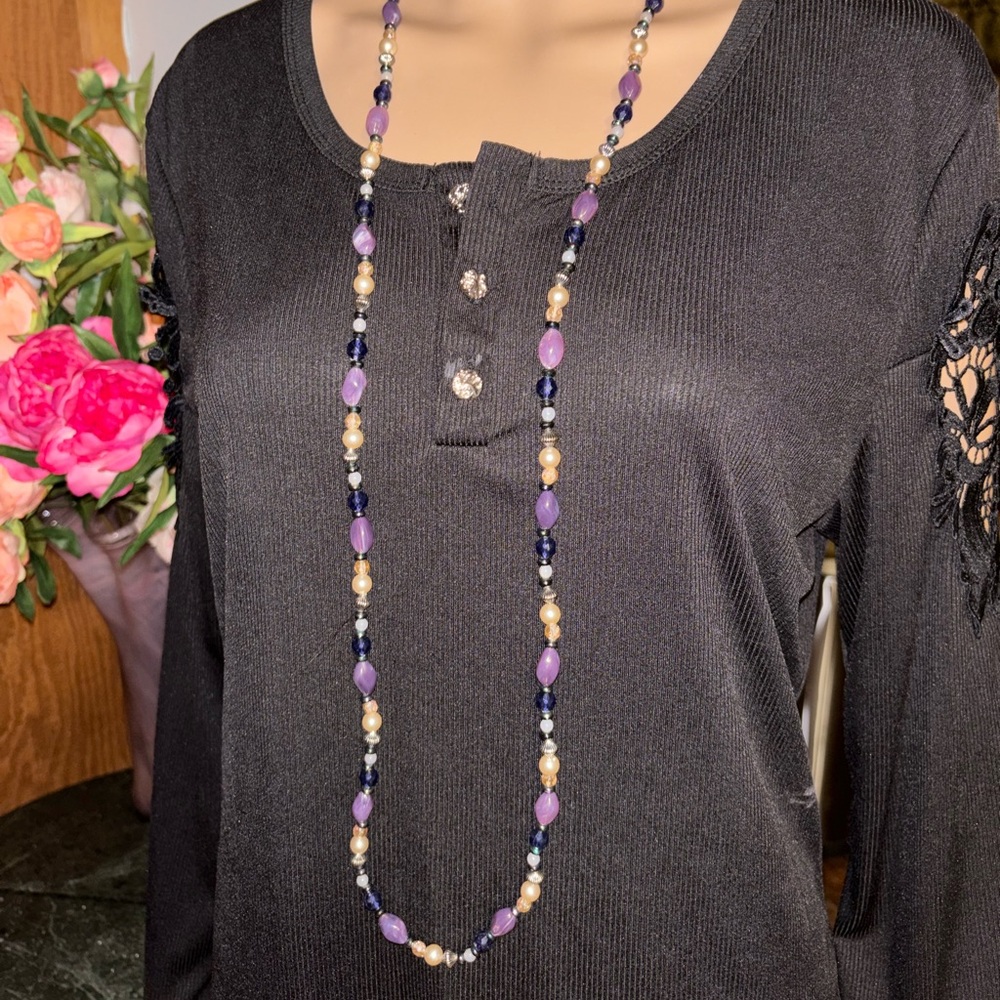 Beautiful gemstone necklace featuring amethyst, quartz, and pearls.